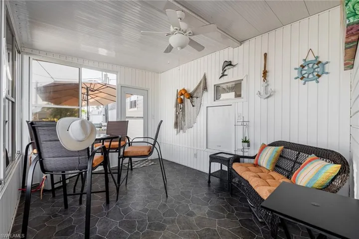 Sunroom / solarium featuring ceiling fan