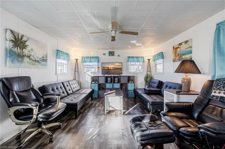 Living area featuring ceiling fan and wood finished floors