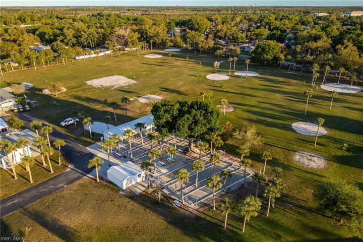 Birds eye view of property featuring a view of trees