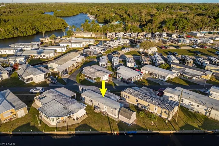 Drone / aerial view with a wooded view, a water view, and a residential view