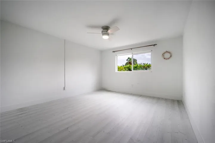 Nice sized bedroom with large window.