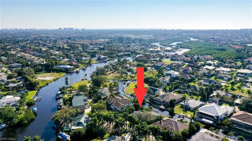 Aerial view featuring a water view and a residential view