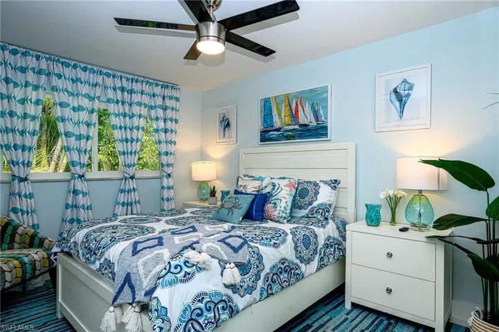 Guest room with closet, sitting area and TV.