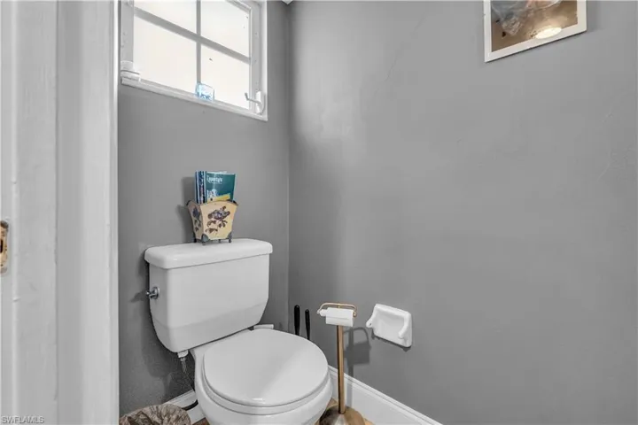 Bathroom with toilet and baseboards