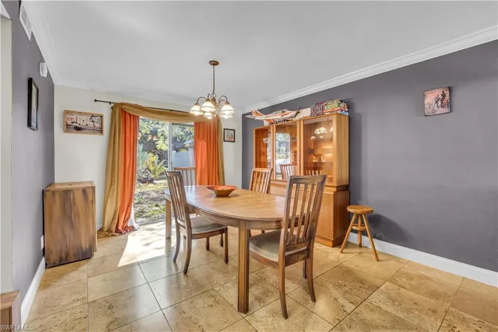 Dining room featuring ornamental molding and hanging lights