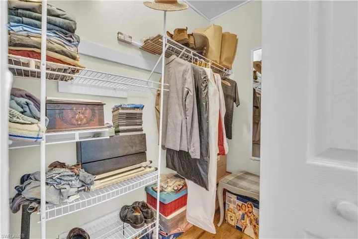 Walk in closet with light wood-type flooring