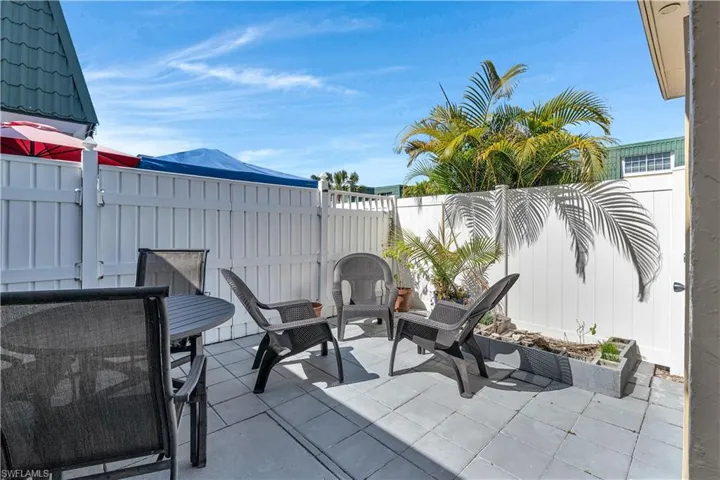 Fenced courtyard with a patio and outdoor dining space