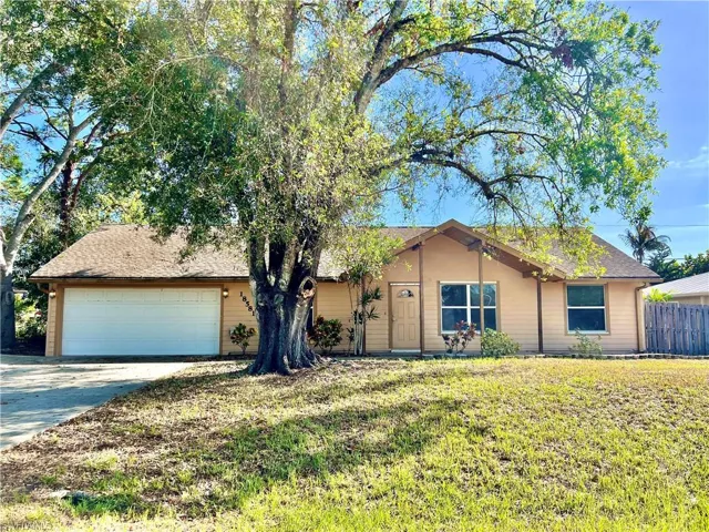Single story home with a front lawn and a garage