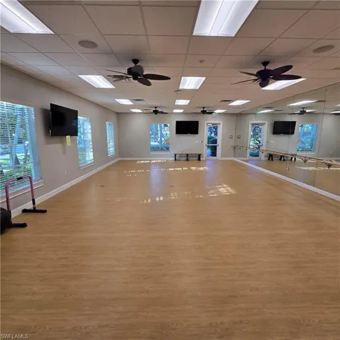 Workout area featuring a paneled ceiling and ceiling fan