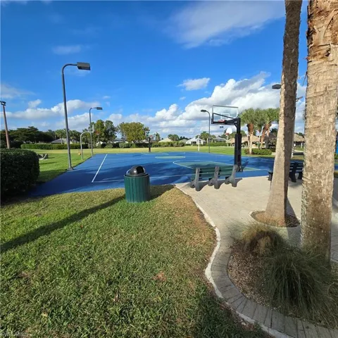 View of sport court featuring community basketball court and a lawn