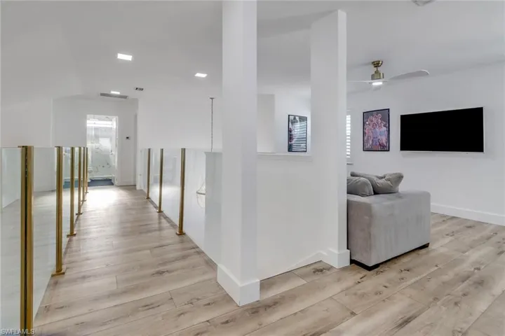Corridor featuring baseboards and light wood-style flooring
