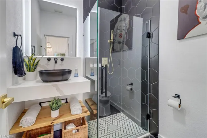 Full bathroom featuring a shower stall and vanity