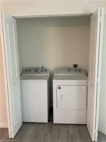 Washroom featuring washing machine and dryer