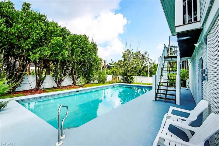 View of pool featuring a fenced backyard, stairway, a fenced in pool, and a patio