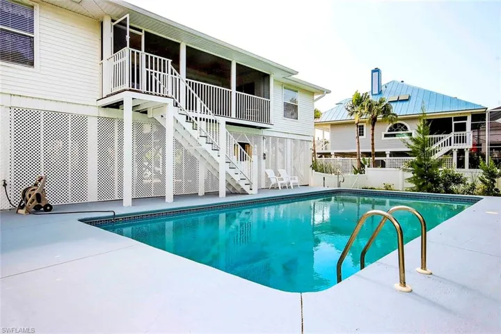 View of swimming pool with fence, a fenced in pool, a patio, and stairs
