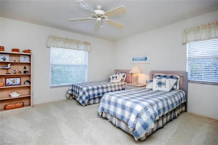 Bedroom featuring ceiling fan, carpet flooring, and baseboards
