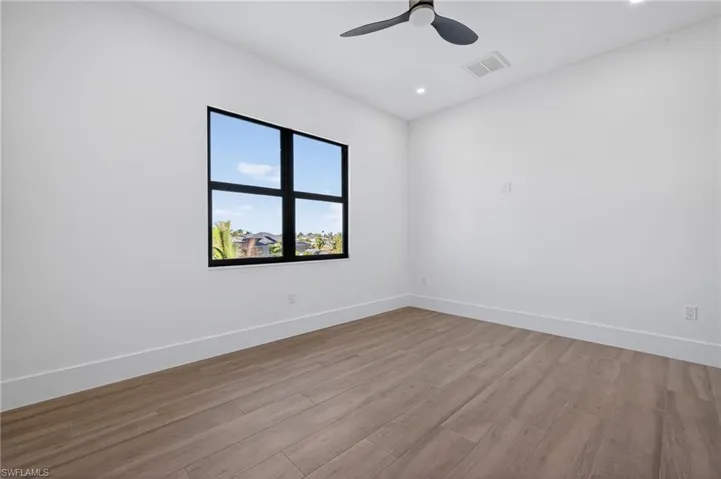Spare room with wood finished floors, recessed lighting, and ceiling fan