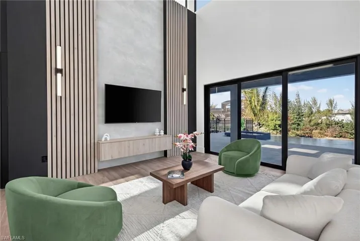 Living area featuring wood finished floors and a high ceiling