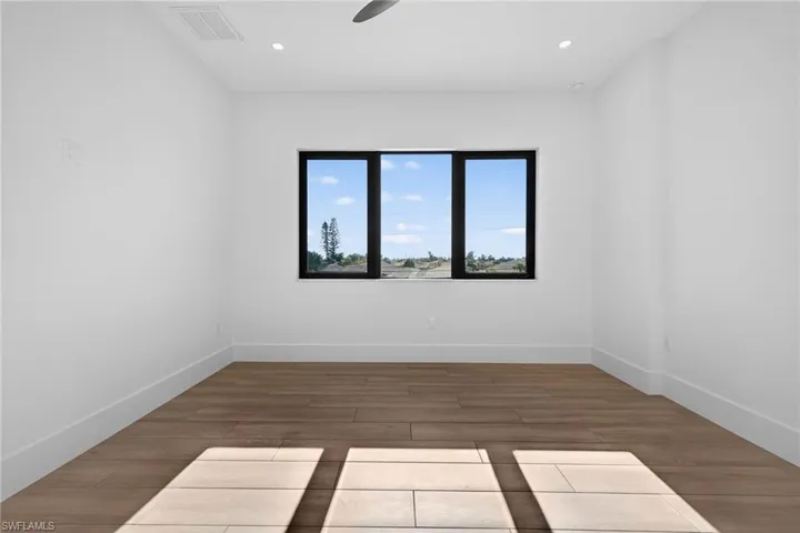 Spare room with wood finished floors, recessed lighting, and a ceiling fan