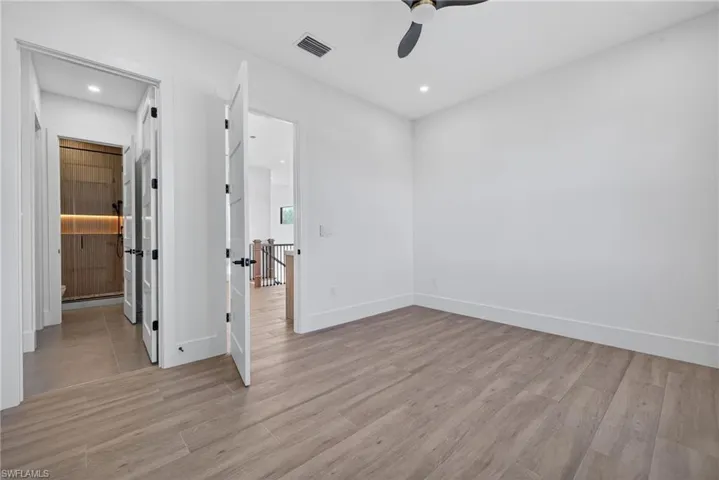 Unfurnished bedroom with light wood-style flooring, a ceiling fan, and recessed lighting