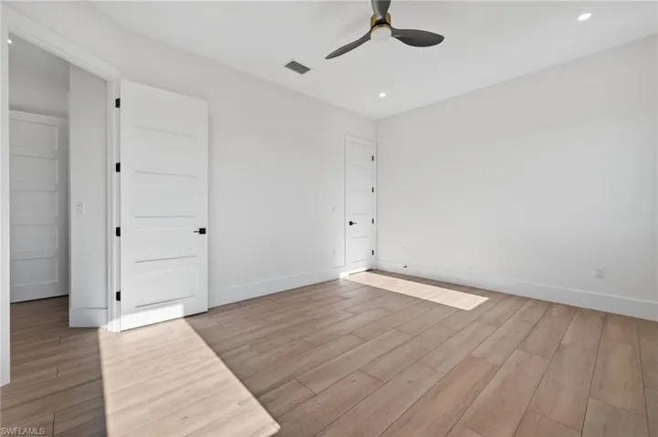 Unfurnished bedroom featuring wood finish floors, a ceiling fan, and recessed lighting