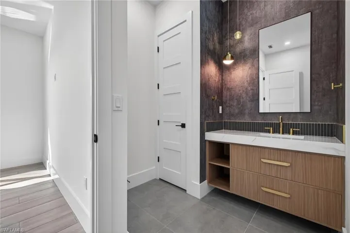 Bathroom featuring vanity and baseboards
