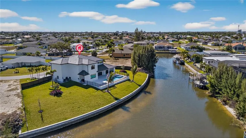 Aerial perspective of suburban area with a large body of water