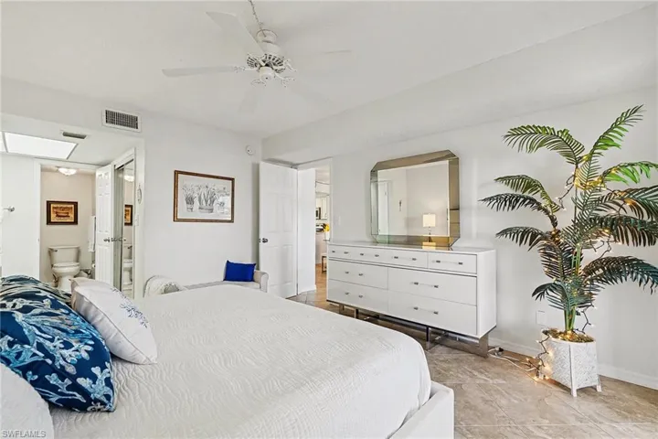 Bedroom with ceiling fan and ensuite bath
