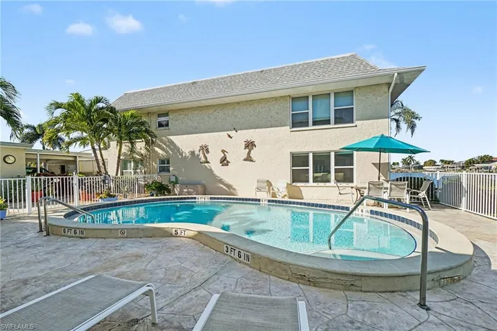 Community pool with a patio