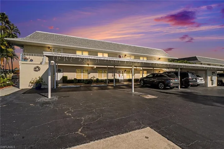 Parking at dusk featuring covered parking