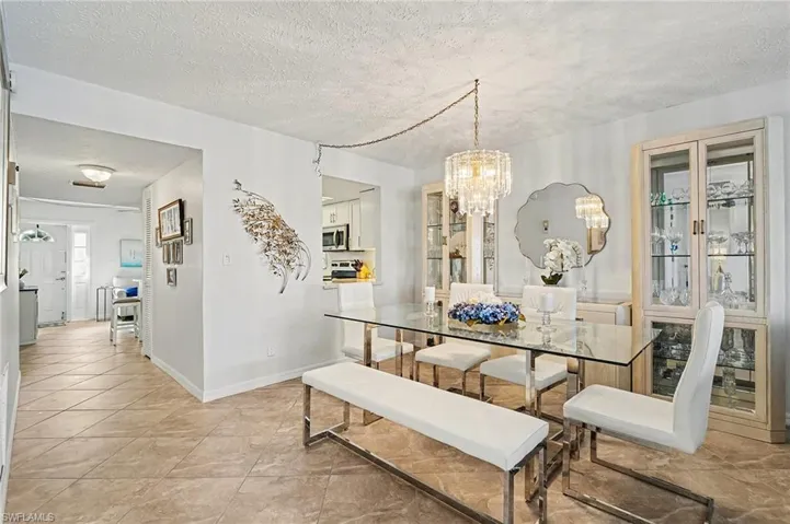 Dining space with a textured ceiling and a chandelier