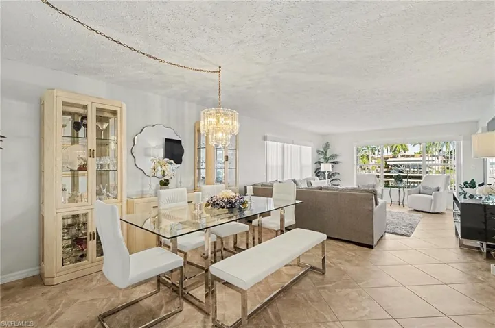 Dining area with a chandelier and a textured ceiling