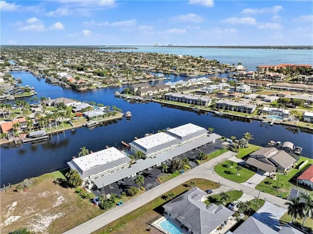 Aerial perspective of suburban area featuring a nearby body of water