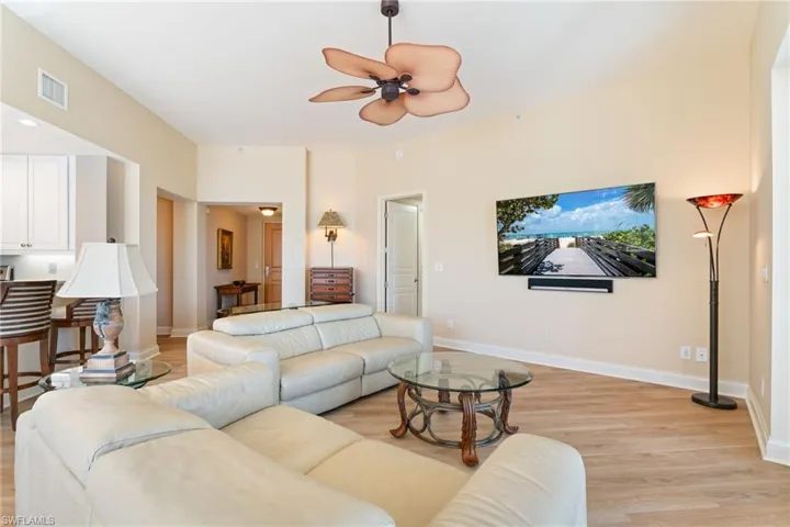 Living area with light wood-type flooring and a ceiling fan