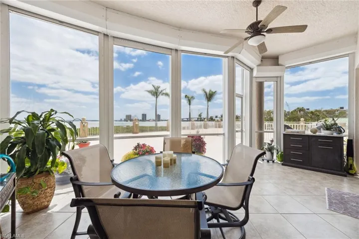 Sunroom / solarium featuring tile patterned flooring and a textured ceiling