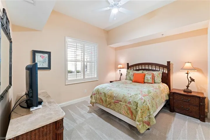 Bedroom with light carpet and ceiling fan