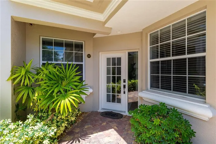 Doorway to property with stucco siding