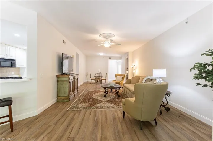 Living area with light wood-style floors and ceiling fan
