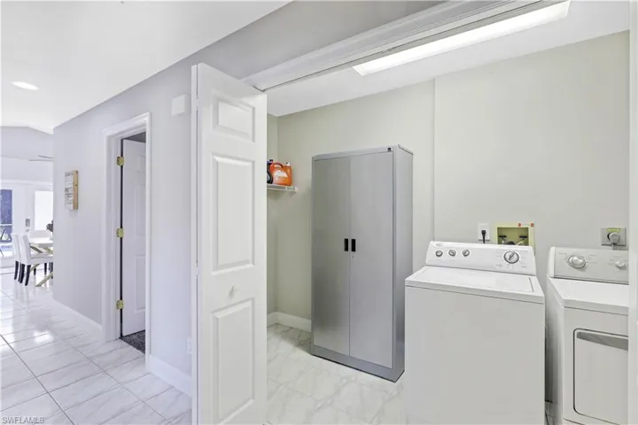 Laundry area featuring baseboards and separate washer and dryer