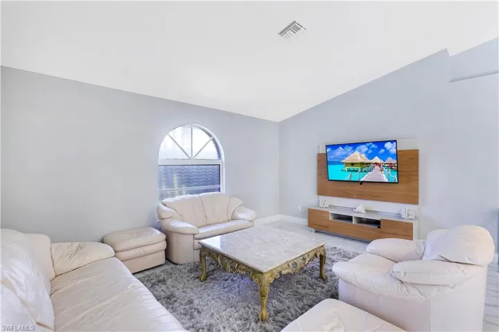 Living room featuring lofted ceiling