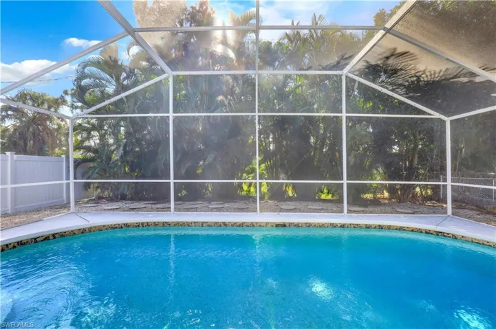 Swimming pool with a lanai and a sunroom