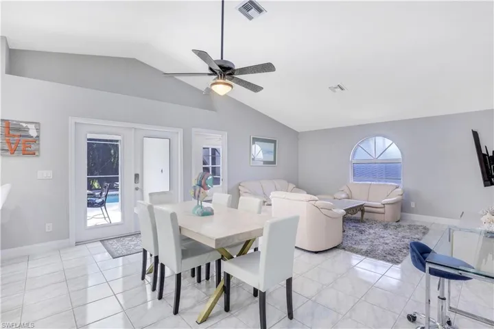 Dining area with french doors, ceiling fan, and light tile patterned flooring