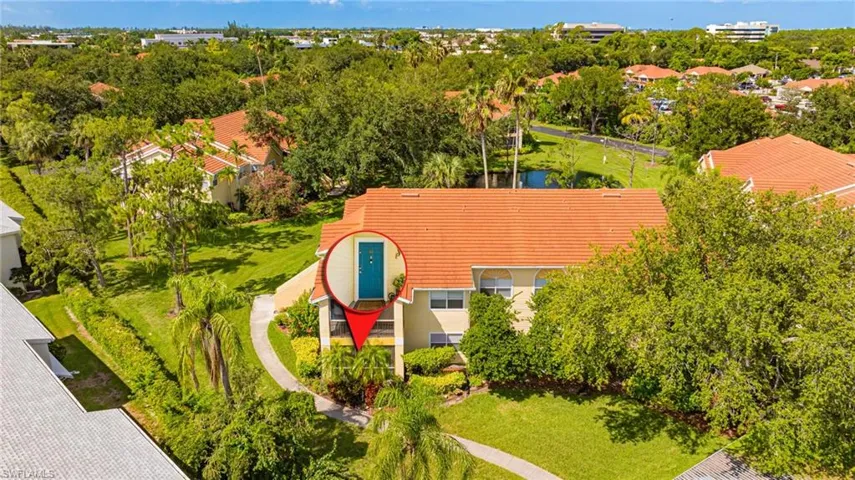 View of subject property featuring a tree filled landscape