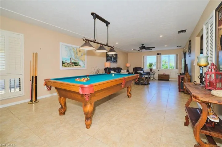 This entire room can be used as your huge living room area if you like.  Furnished with the pool table (can be removed and donated prior to closing if you don't want it)  Unless you want a formal dining room this area can be separated into a den/office.  Believe me - there is plenty of space here!  Options galore!