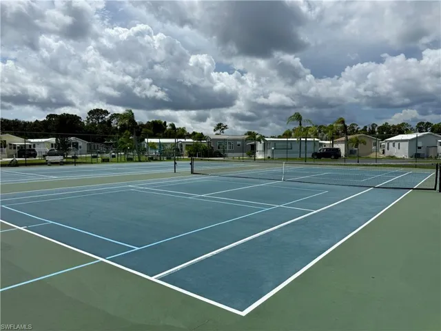 View of tennis court with community basketball court