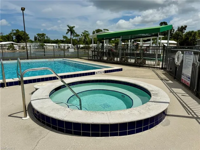 Community pool featuring a community hot tub and a patio area