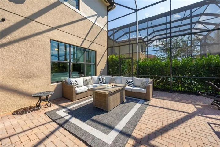View of patio featuring an outdoor living space and glass enclosure