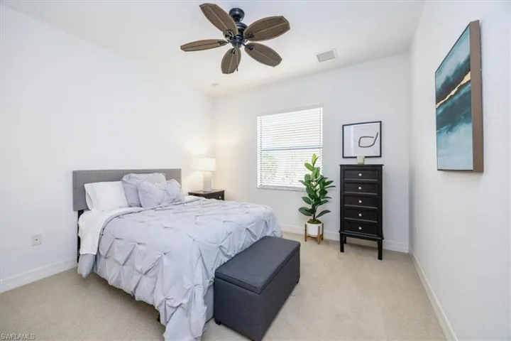 Bedroom featuring ceiling fan and light carpet