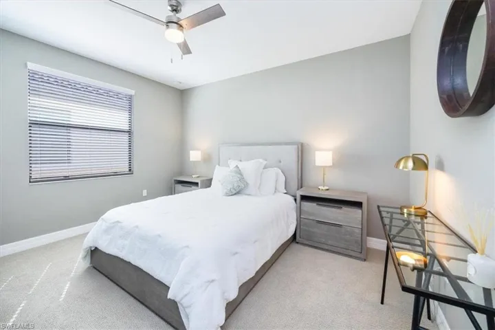 Bedroom featuring light carpet and ceiling fan