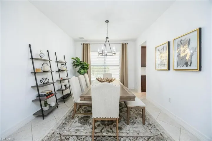 Tiled dining area with a chandelier